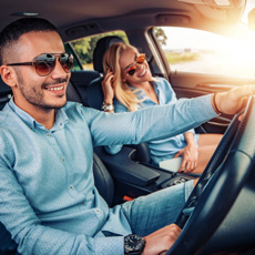 Happy couple driving in a car.