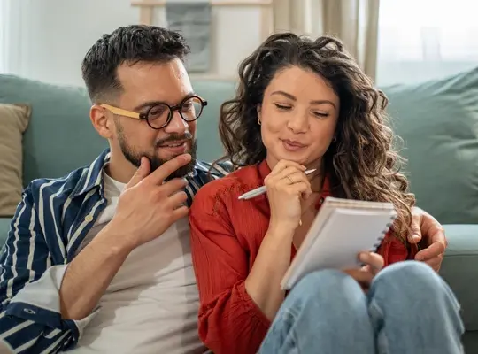 Happy couple reviewing their finances