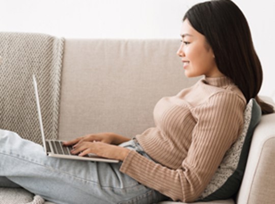 Woman watching a webinar at home on her laptop.