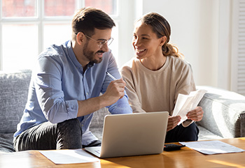 Happy couple discussing finances.