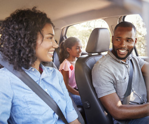 Happy family in their car.