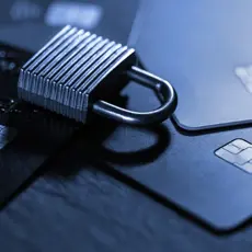 a lady writing fraud alert and a lock