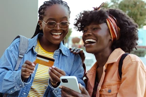 Two young woman shopping with a credit card