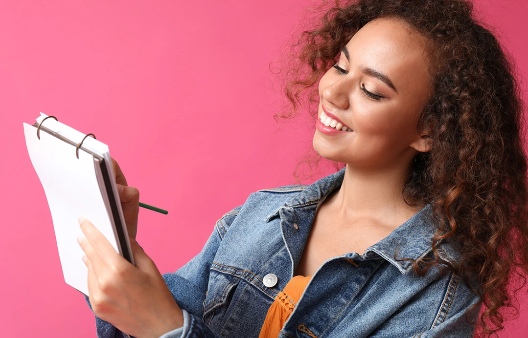 Smiling young woman looking at her new year finances.