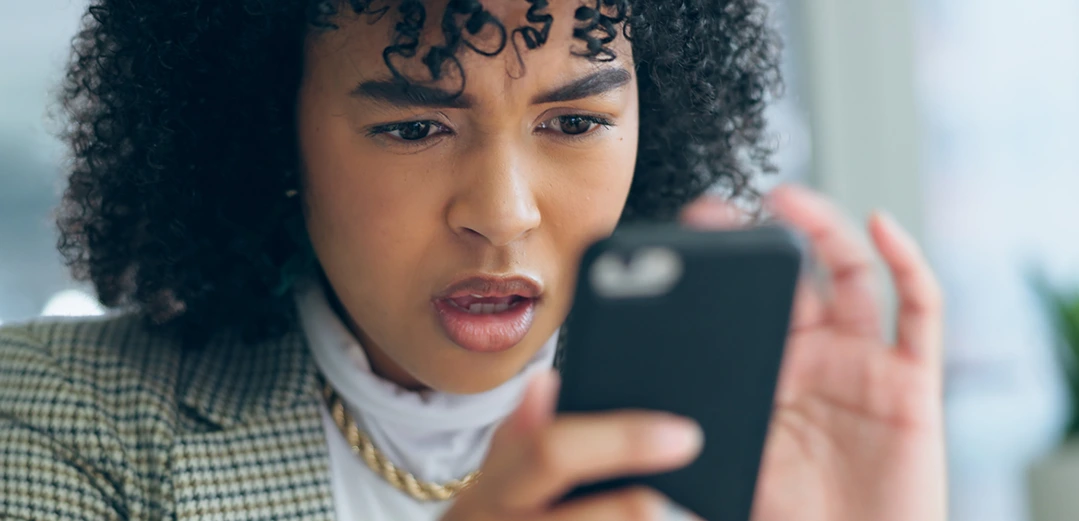 Shocked women looking at Smart Phone