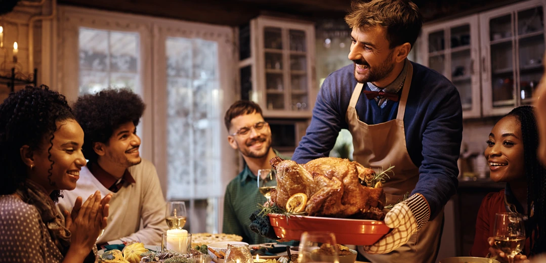 Group of friends sharing Thanksgiving dinner.